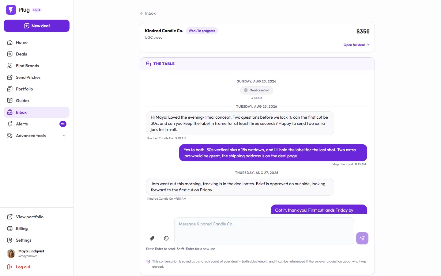 A deal thread on a demo account: the pinned summary for a fictional candle brand's $350 UGC video with Open full deal, then The Table: the brand asks for a 30-second first cut with the label in frame and offers extra jars, the creator agrees, the jars ship, and the note that the conversation is a shared record of the deal.