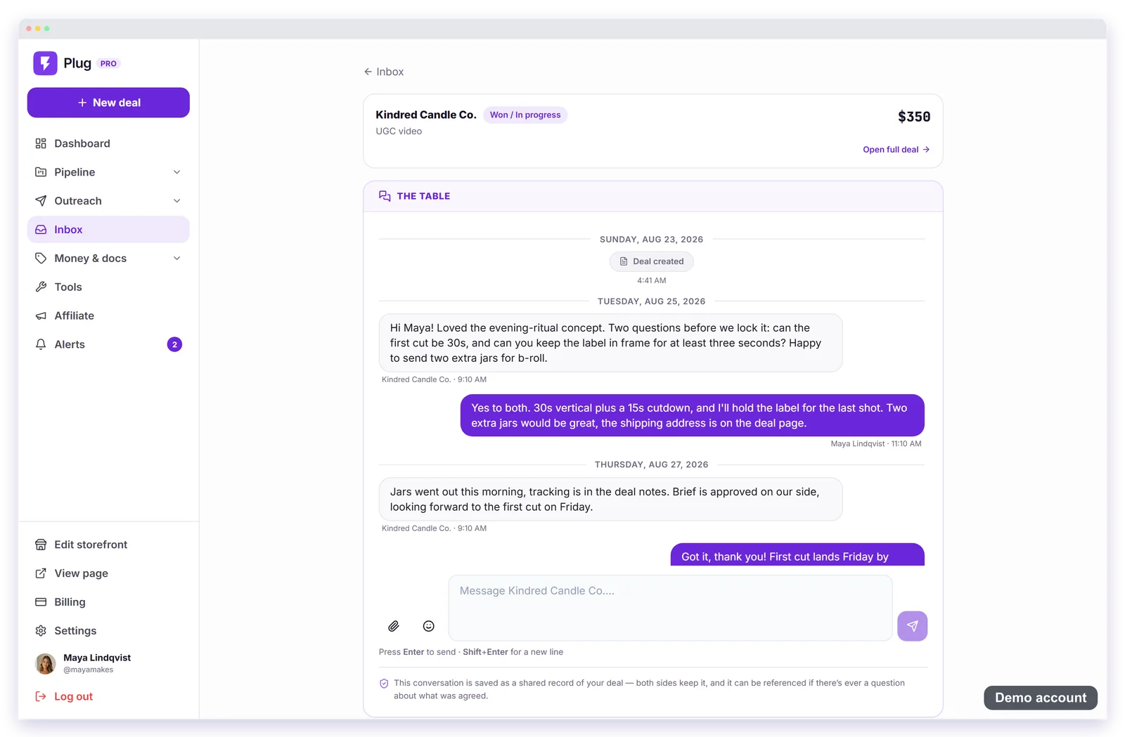 A deal thread on a demo account: the pinned summary for a fictional candle brand with Open full deal, then The Table, a dated conversation about the first cut and extra jars, the reply box, and the note that the conversation is a shared record of the deal.
