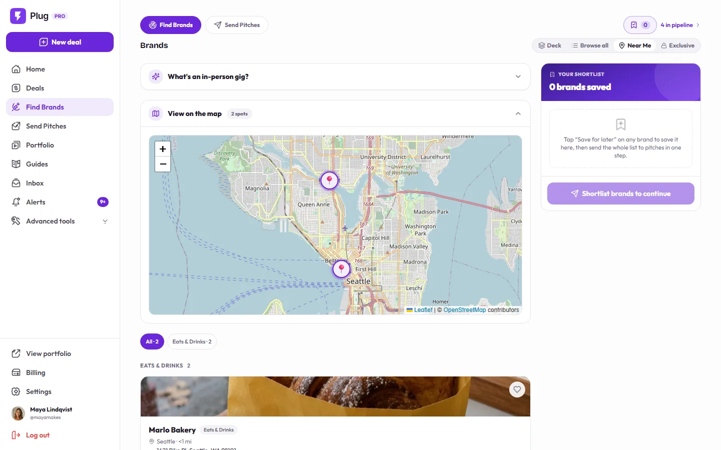 Near Me on a demo account: a map of Seattle with two pinned local spots, the Eats & Drinks filter, and a fictional bakery's gig card.